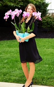 woman holding orchids