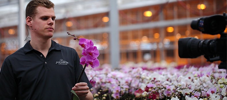 Man holding an orchid